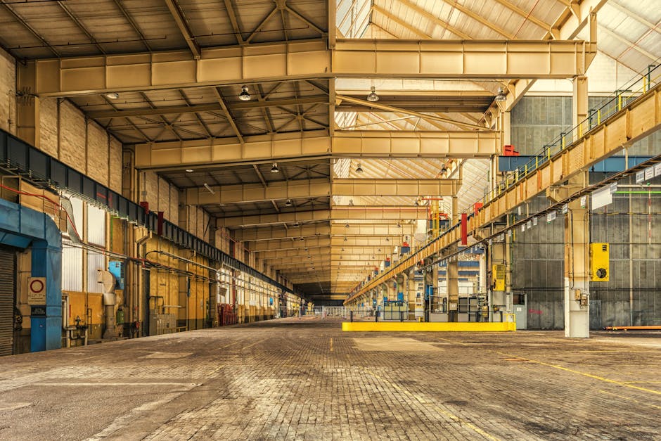 Expansive interior of an industrial warehouse showing steel beams, high ceilings, and ample space